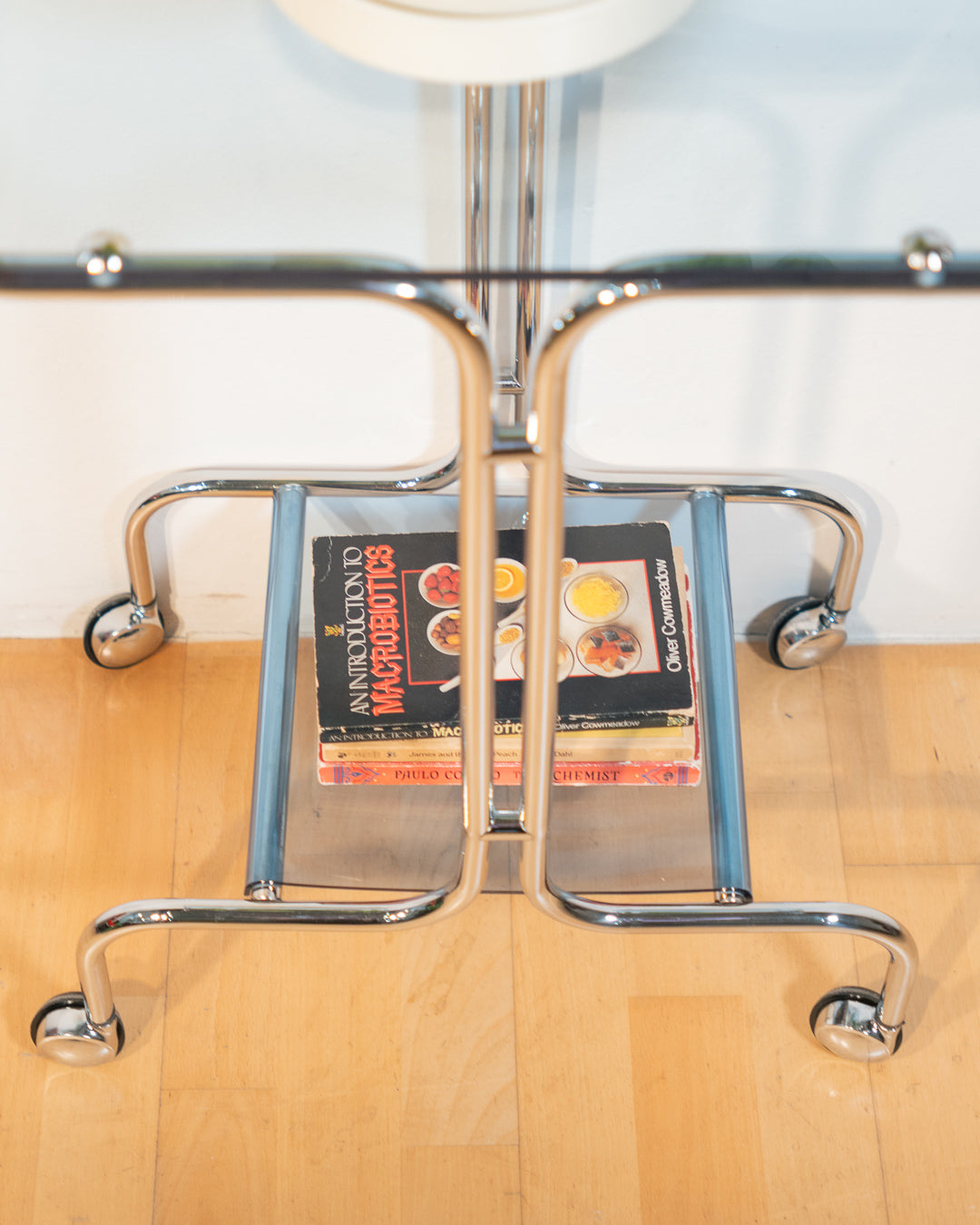 1970s chrome rolling side table with baby blue acrylic shelves, two-level mid-century modern design. Vecino Shop