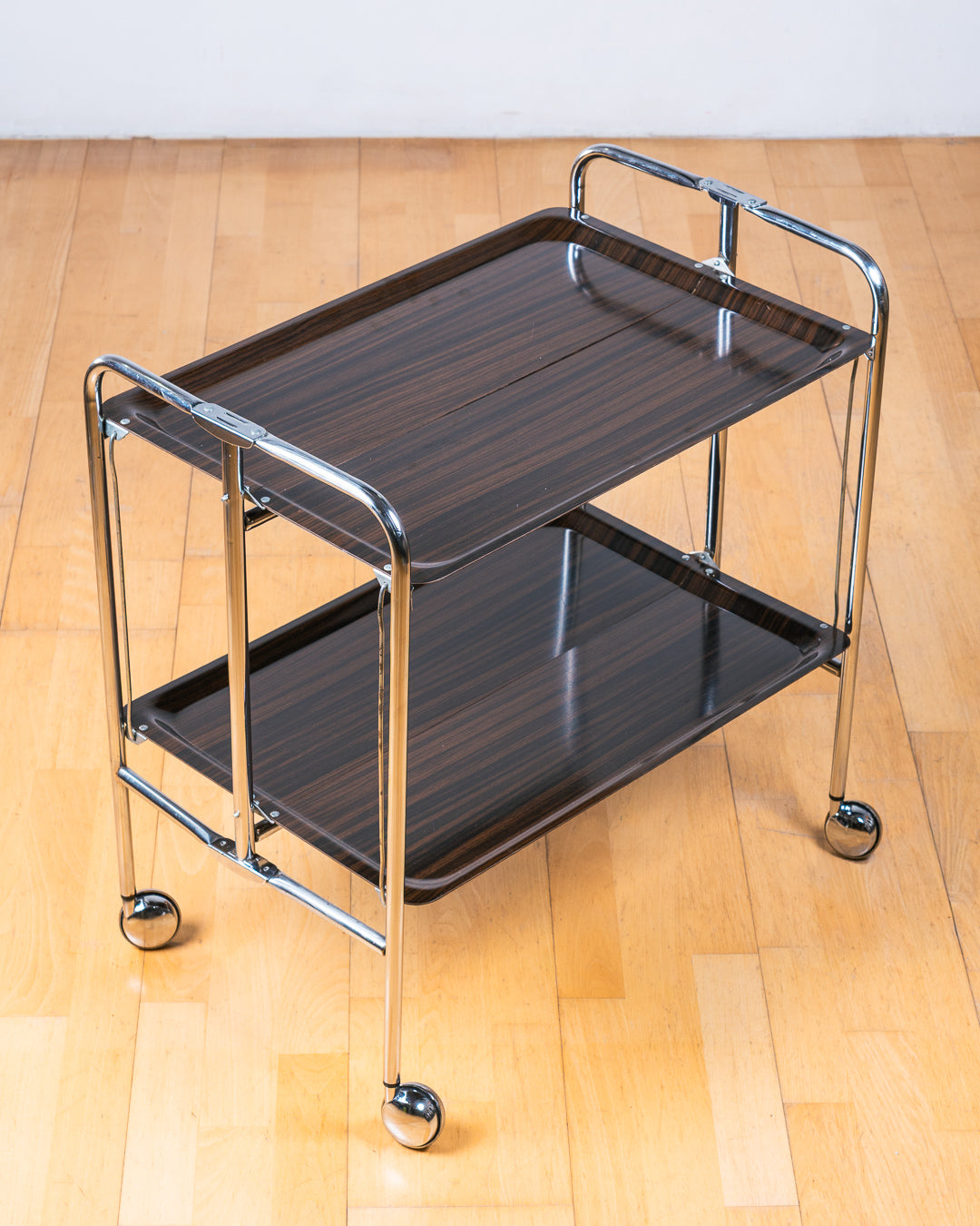 Vintage 1960s dark woodgrain folding trolley with  Formica shelves and chrome details. Made in France. Space Age Bar Cart, drinks trolley. Mid Century Modern. Vecino Shop