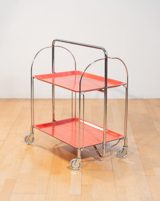 Vintage Gerlinol folding serving trolley 1970s, chrome frame with red salmon wood veneer trays, Mid-Century design, compact foldable bar cart with wood grain detail – Vecino Shop