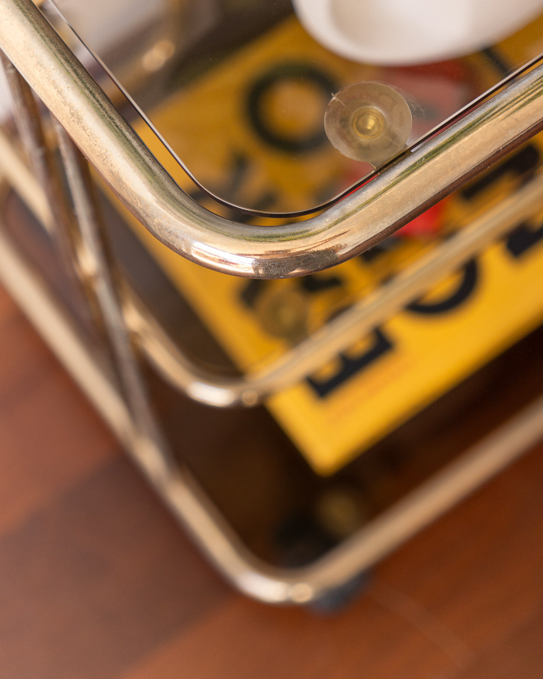 Vintage 1970s gold and smoked glass 3-tier rolling table with worn gold finish