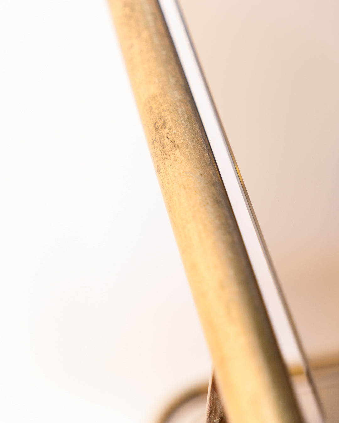 Vintage 1970s gold and smoked glass 3-tier rolling table with worn gold finish