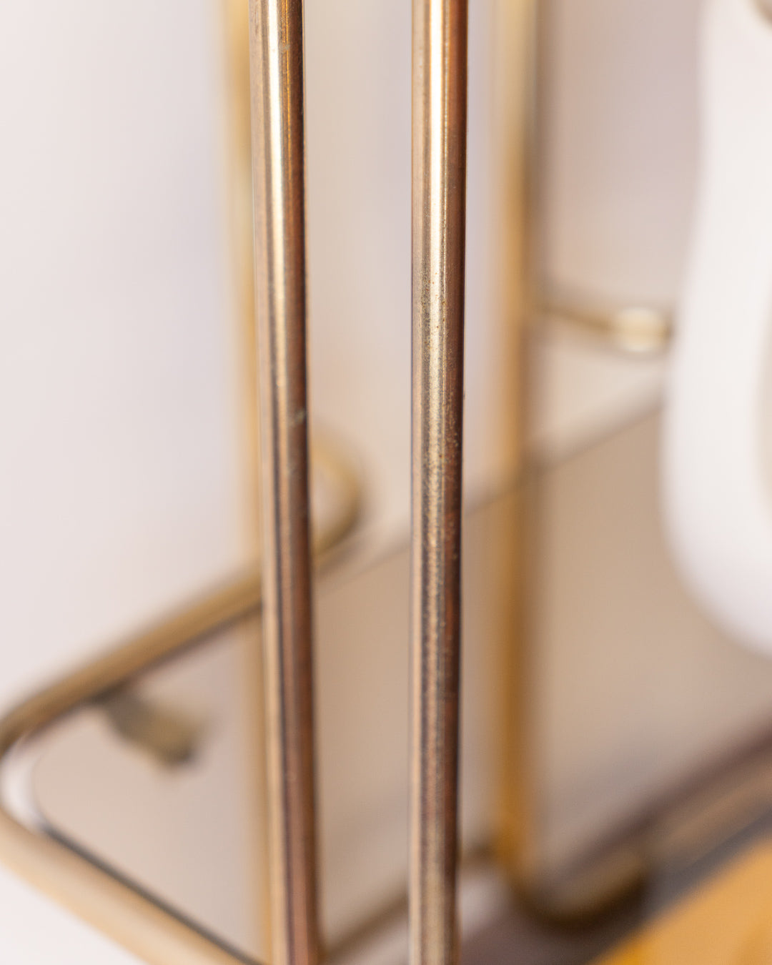 Vintage 1970s gold and smoked glass 3-tier rolling table with worn gold finish