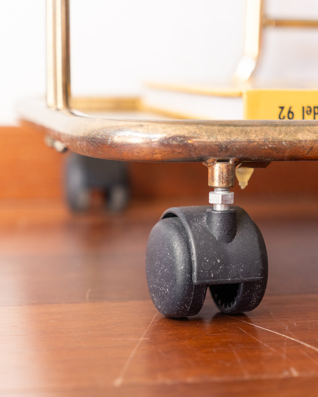 Vintage 1970s gold and smoked glass 3-tier rolling table with worn gold finish