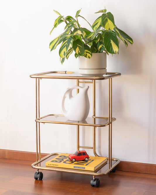 Vintage 1970s gold and smoked glass 3-tier rolling table with worn gold finish
