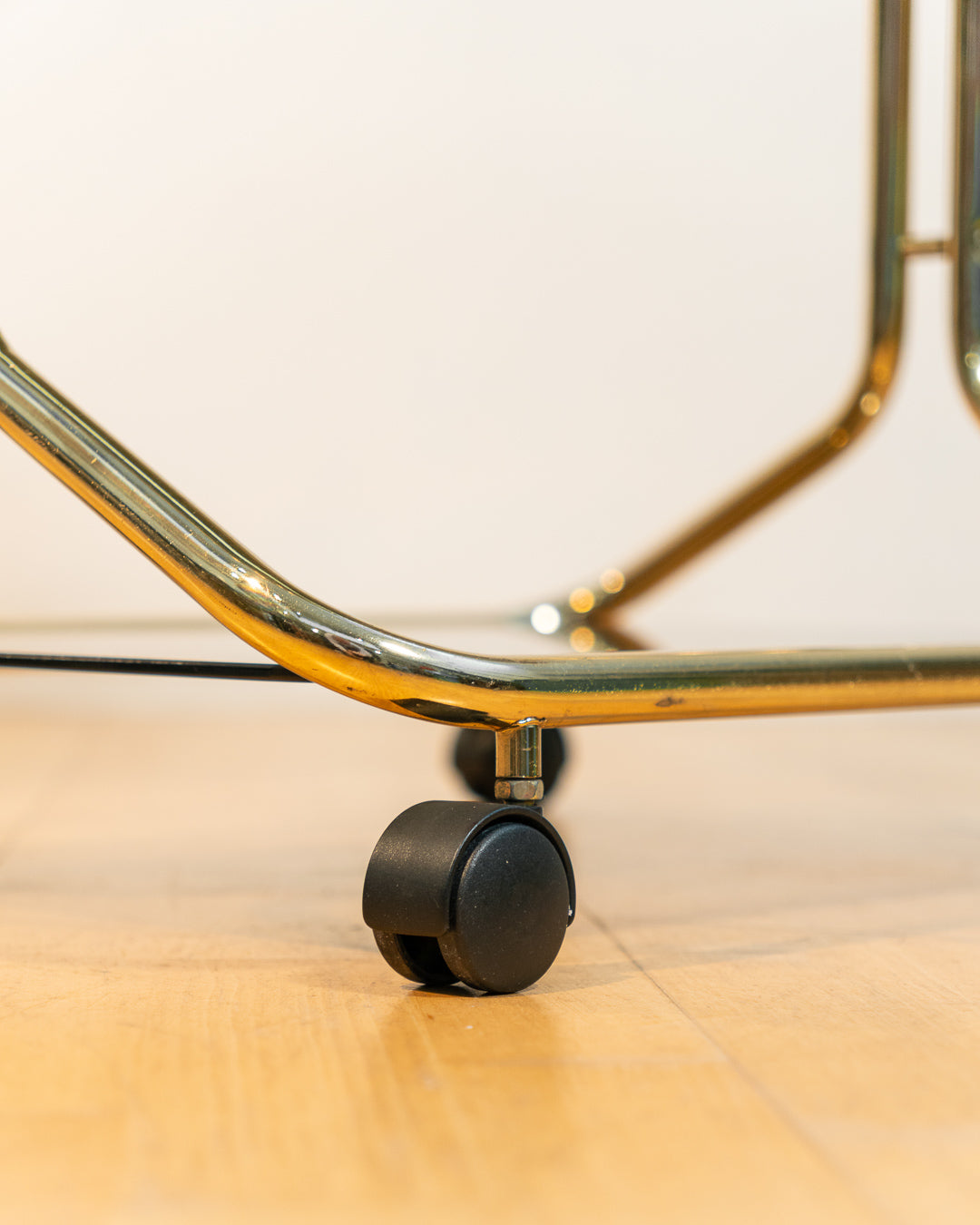 Rare 1970s tubular gold rolling side table with three smoked glass tiers and wheels, vintage Space Age design. Vecino Shop