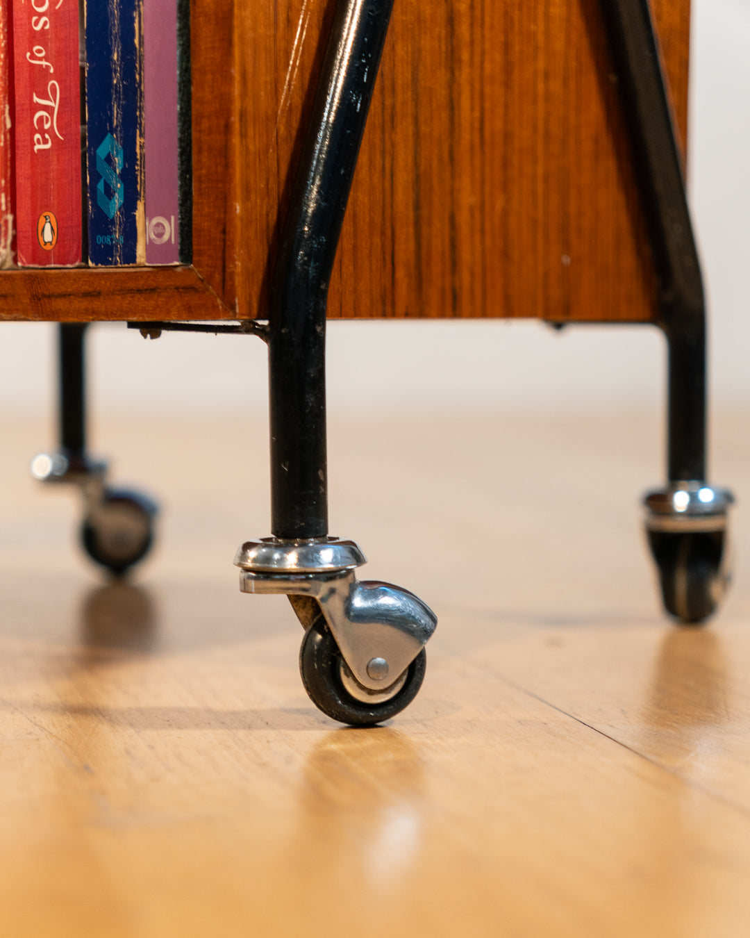 1960s mid-century rolling side table, wood veneer top, chrome frame, built-in bookcase. Vecino Shop