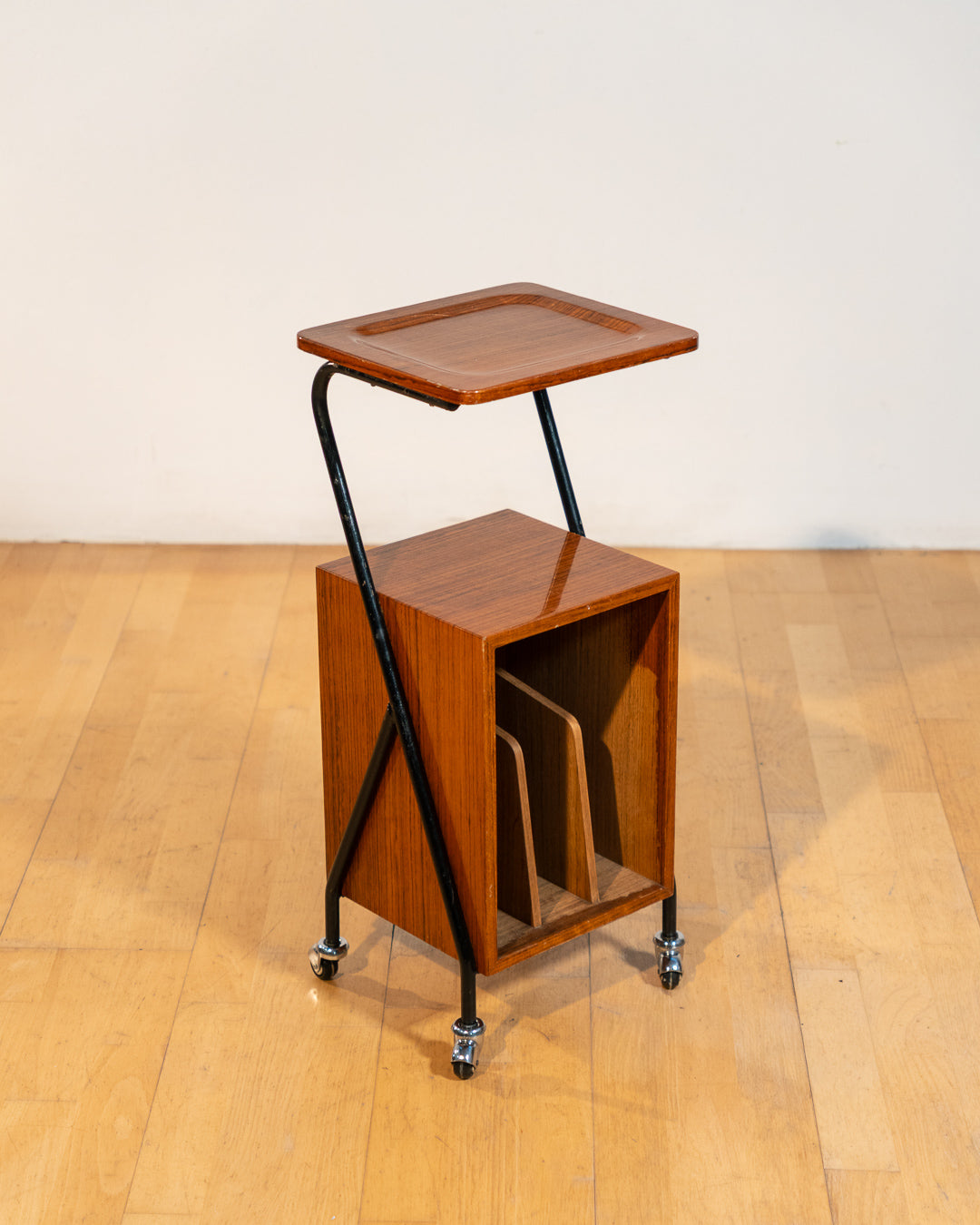 1960s mid-century rolling side table, wood veneer top, chrome frame, built-in bookcase. Vecino Shop