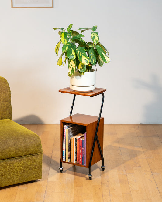 1960s mid-century rolling side table, wood veneer top, chrome frame, built-in bookcase. Vecino Shop