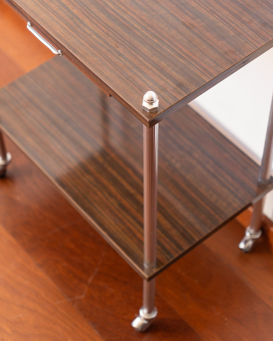 Vintage MCM 1960s chrome and wood veneer rolling table with drawer and caster wheels