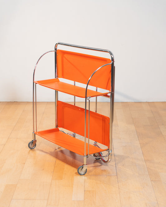 Vintage folding serving trolley 1960s, chrome frame with thin molded orange plastic trays, compact foldable bar cart, Mid-Century / Space Age style, attributed HG Voni – Vecino Shop