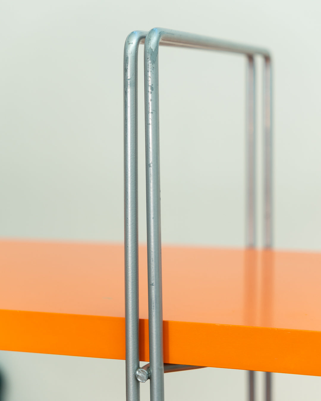 Vintage IKEA ENETRI shelving unit in rare orange finish with four shelves and silver metal wire frame from the 1990s. Vecino Shop