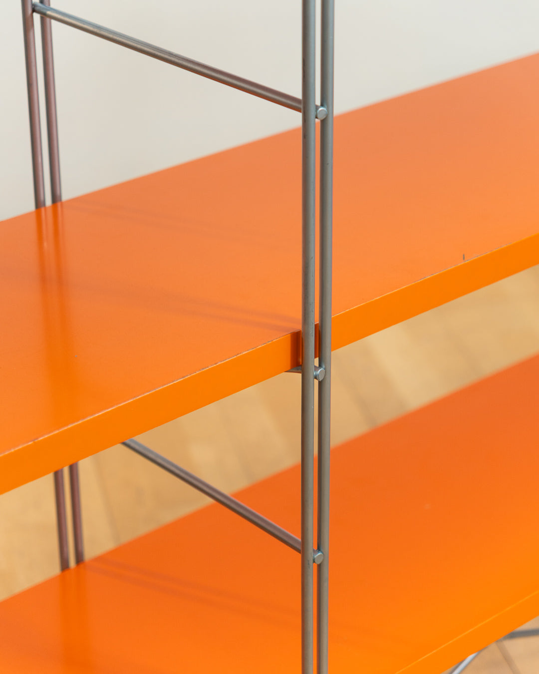Vintage IKEA ENETRI shelving unit in rare orange finish with four shelves and silver metal wire frame from the 1990s. Vecino Shop