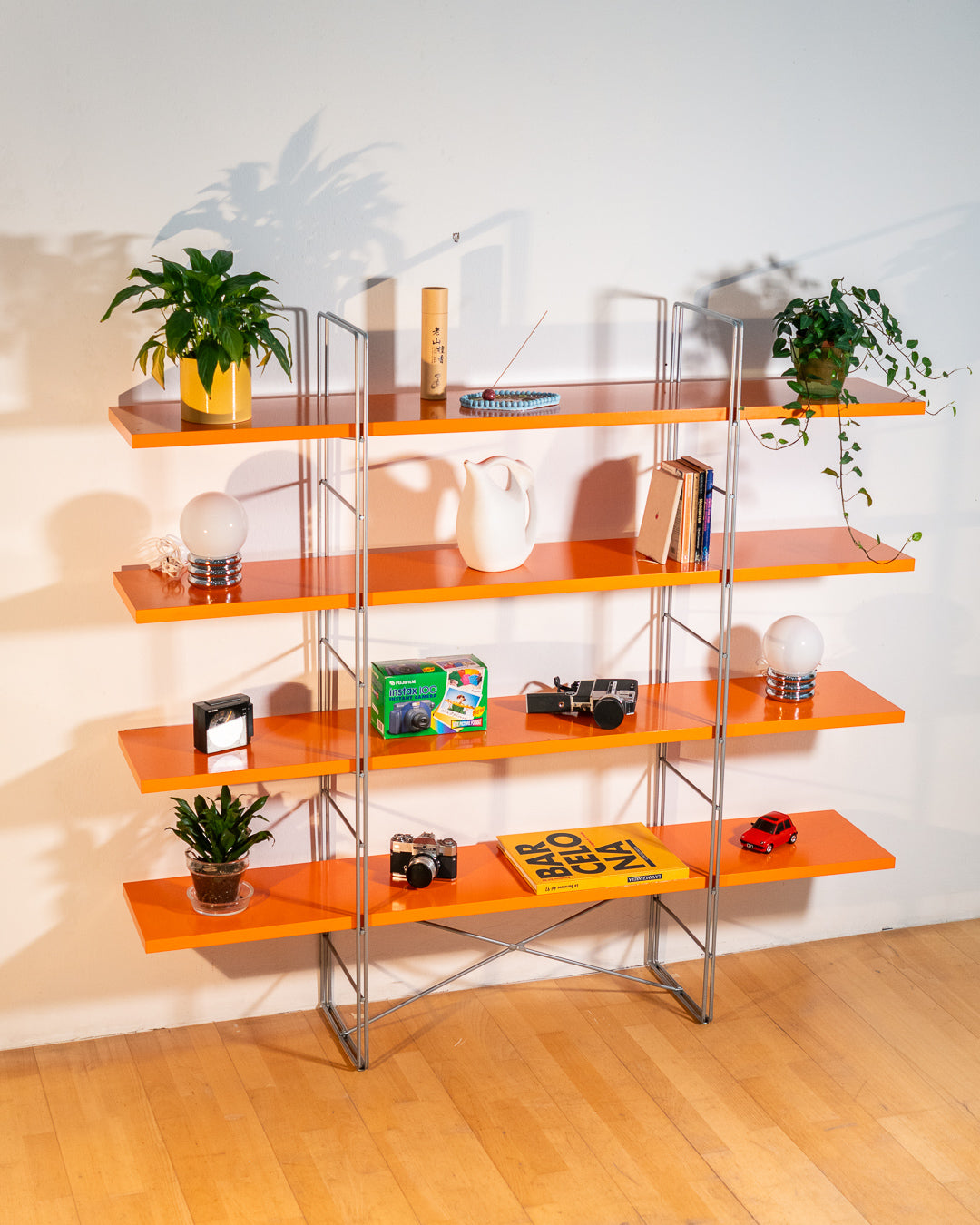 Vintage IKEA ENETRI shelving unit in rare orange finish with four shelves and silver metal wire frame from the 1990s. Vecino Shop