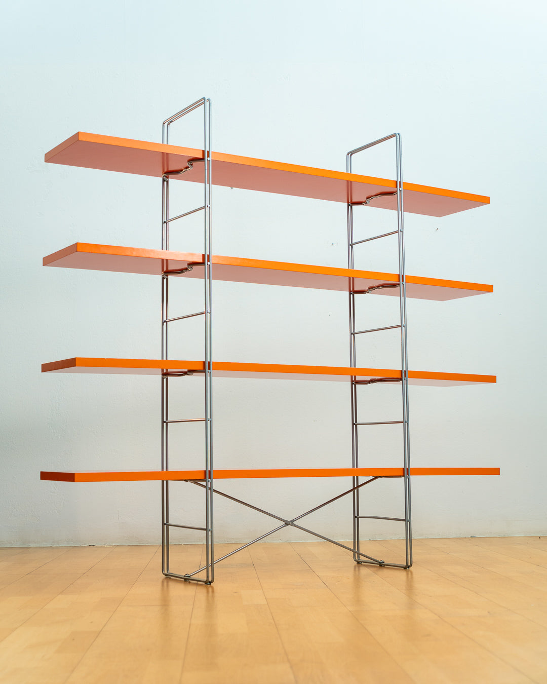 Vintage IKEA ENETRI shelving unit in rare orange finish with four shelves and silver metal wire frame from the 1990s. Vecino Shop