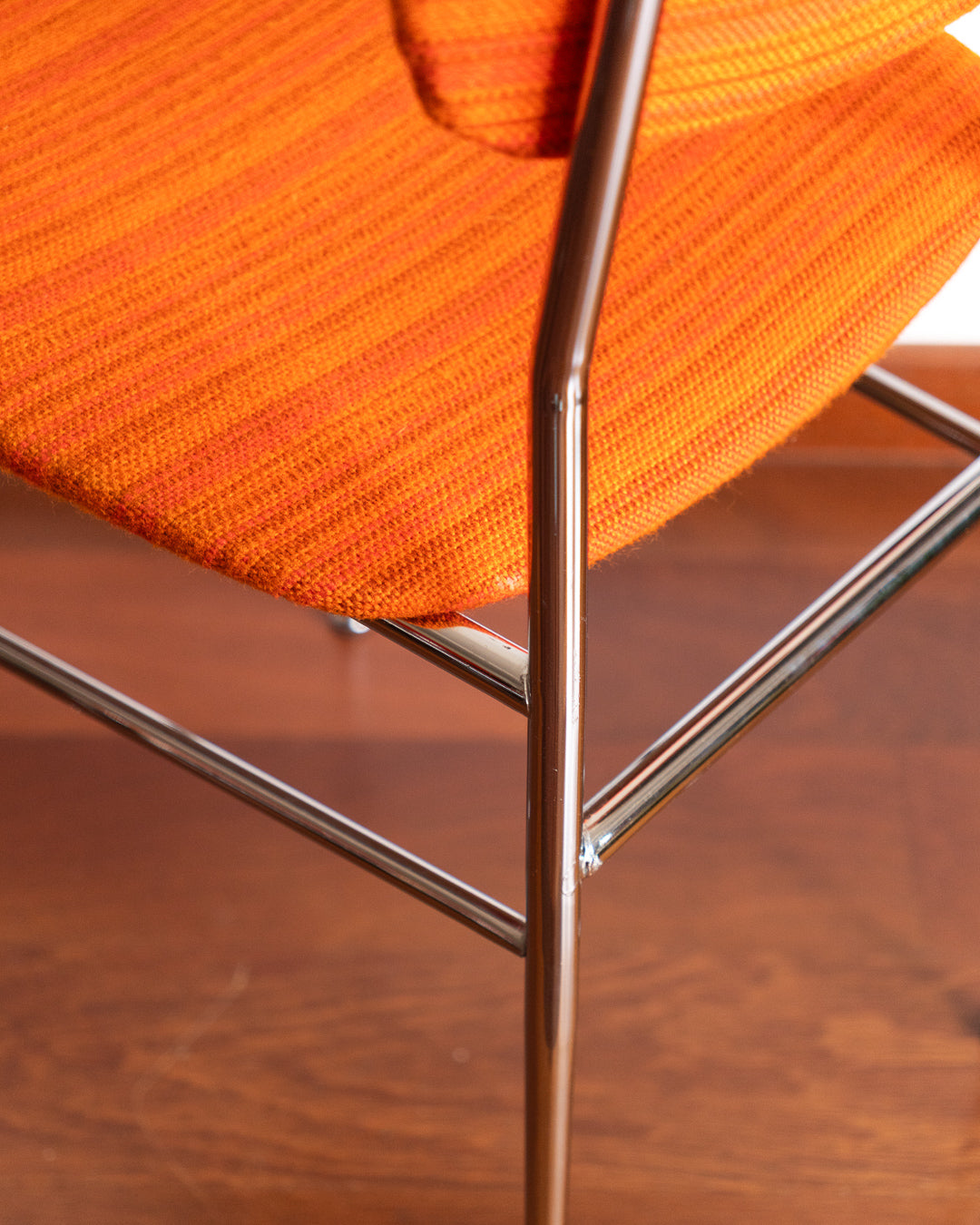 Pair of 1960s Space Age chrome chairs with orange striped fabric upholstery.