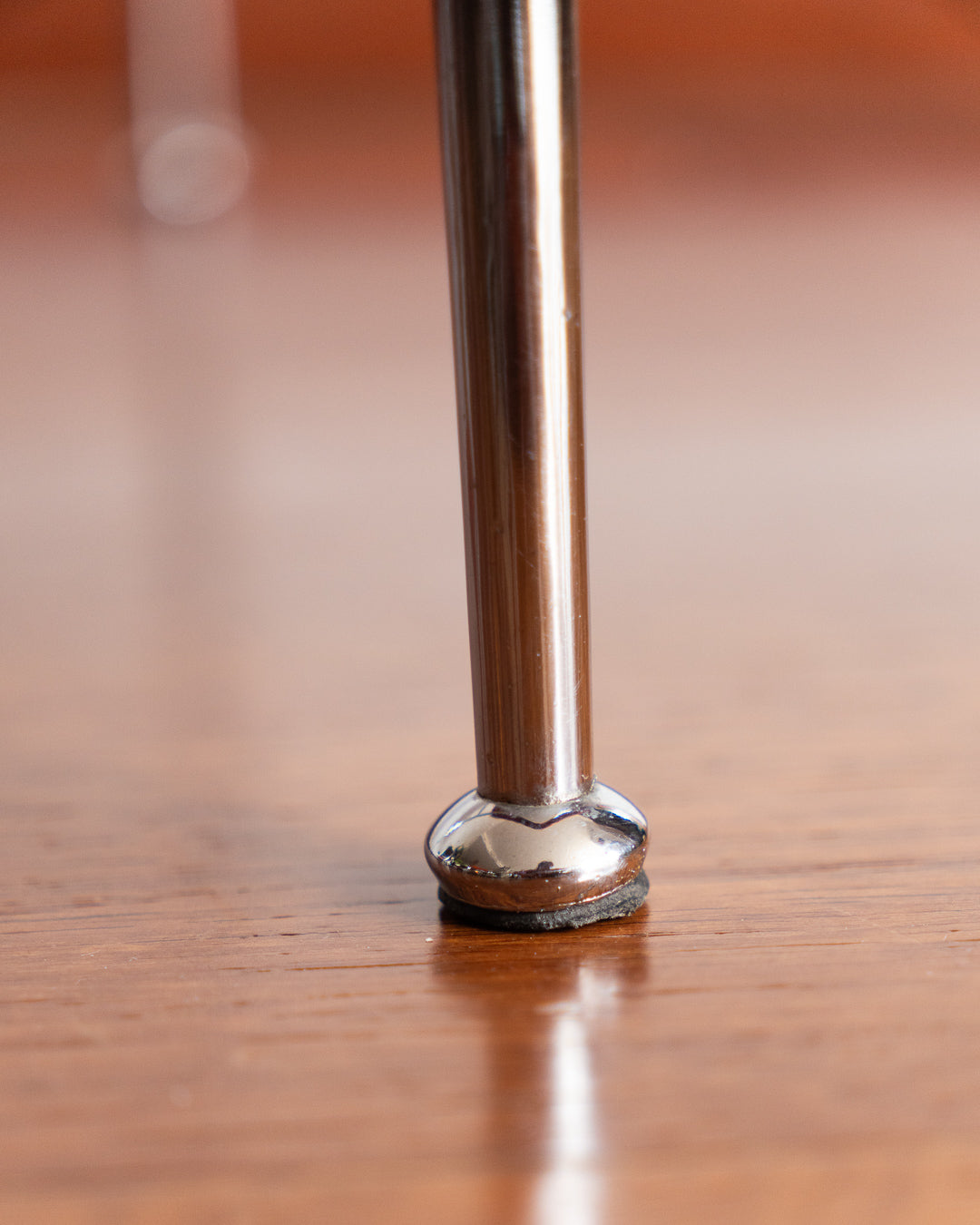 Pair of 1960s Space Age chrome chairs with orange striped fabric upholstery.