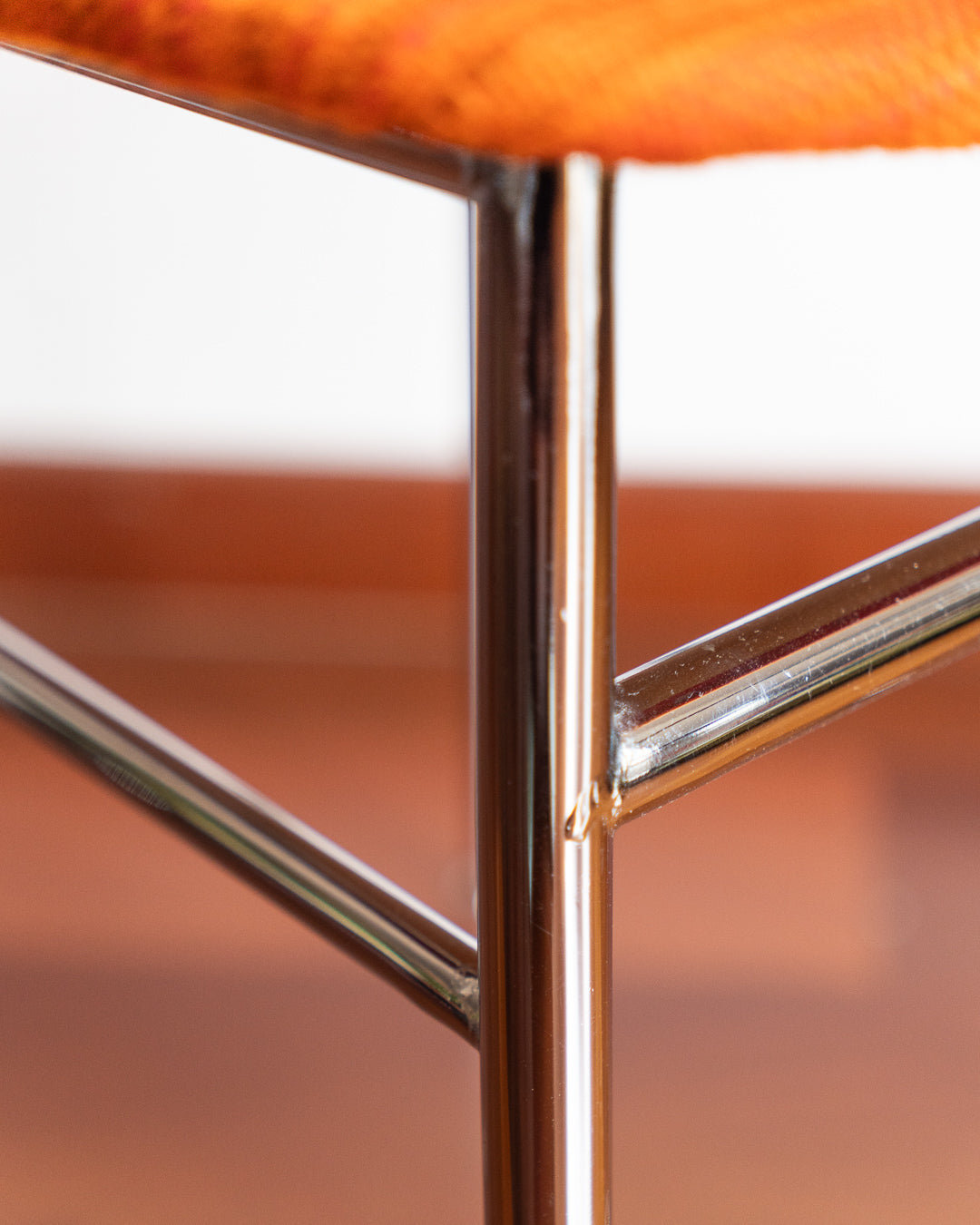 Pair of 1960s Space Age chrome chairs with orange striped fabric upholstery.