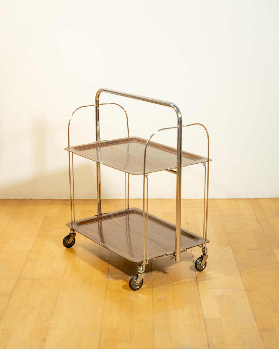 Vintage Raquer folding serving trolley 1960s, chrome frame with dark wood veneer shelves, Mid-Century design, compact foldable bar cart, similar to Dinnet and other classic European brands – Vecino Shop