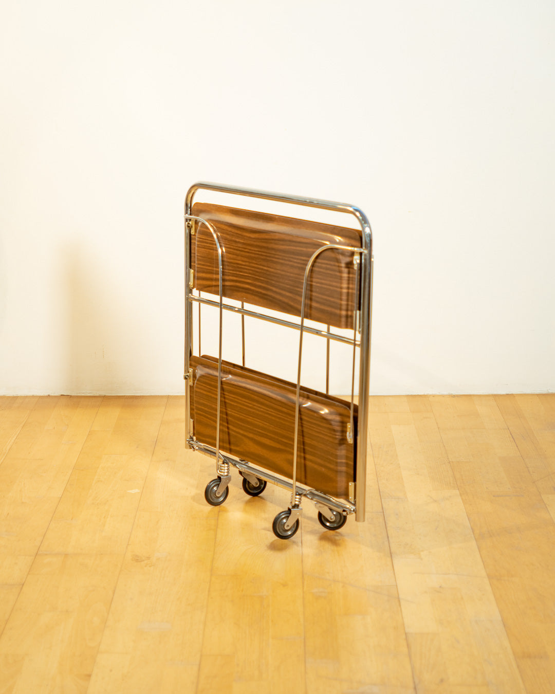 Vintage Raquer folding serving trolley 1960s, chrome frame with dark wood veneer shelves, Mid-Century design, compact foldable bar cart, similar to Dinnet and other classic European brands – Vecino Shop