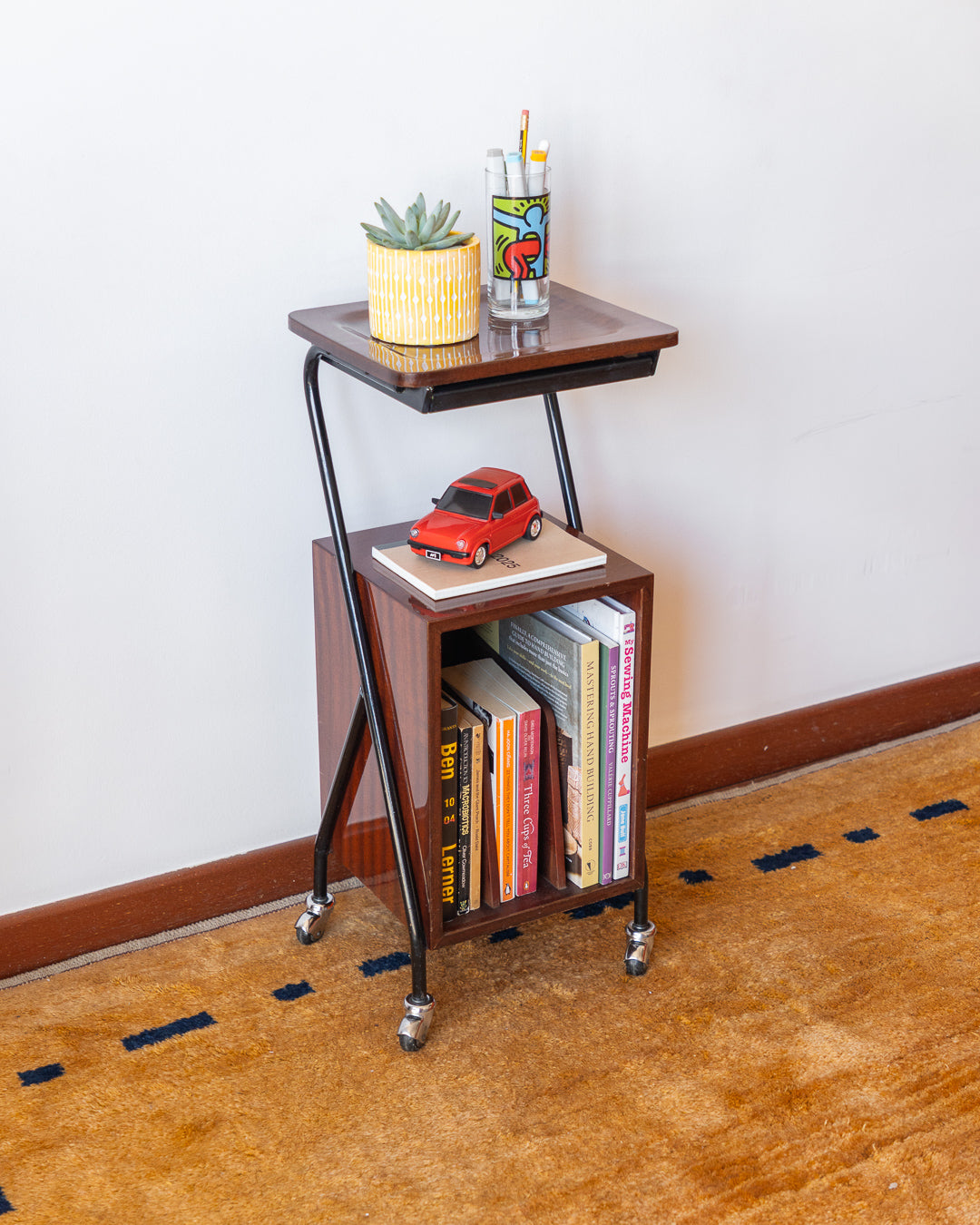 Vintage 1960s wooden rolling side table with black metal frame, magazine rack – Vecino Shop