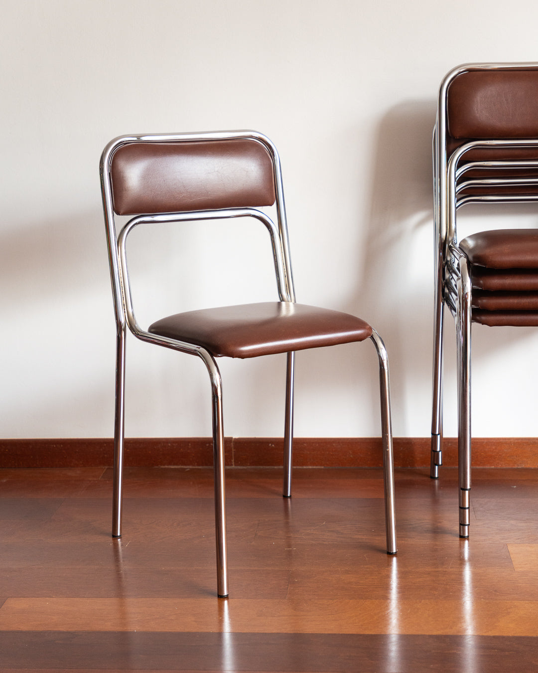 Set of five 1970s–80s Bauhaus-style chrome chairs with brown vinyl upholstery.