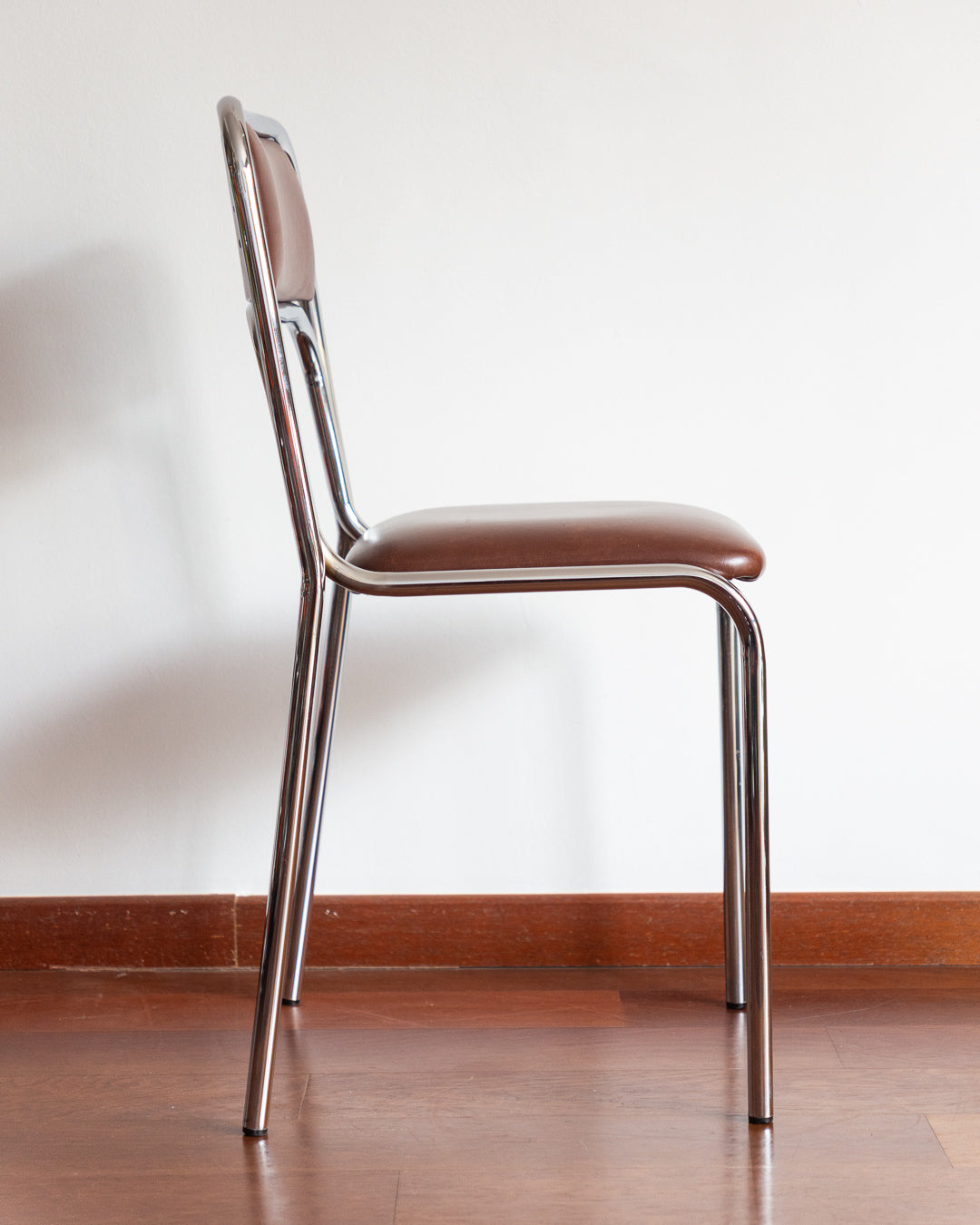 Set of five 1970s–80s Bauhaus-style chrome chairs with brown vinyl upholstery.