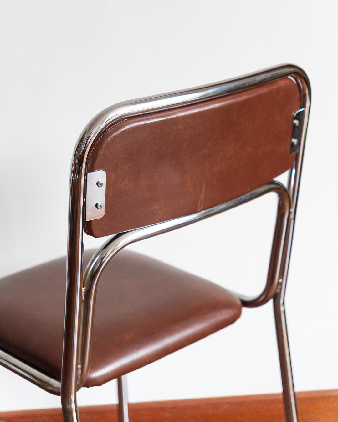 Set of five 1970s–80s Bauhaus-style chrome chairs with brown vinyl upholstery.
