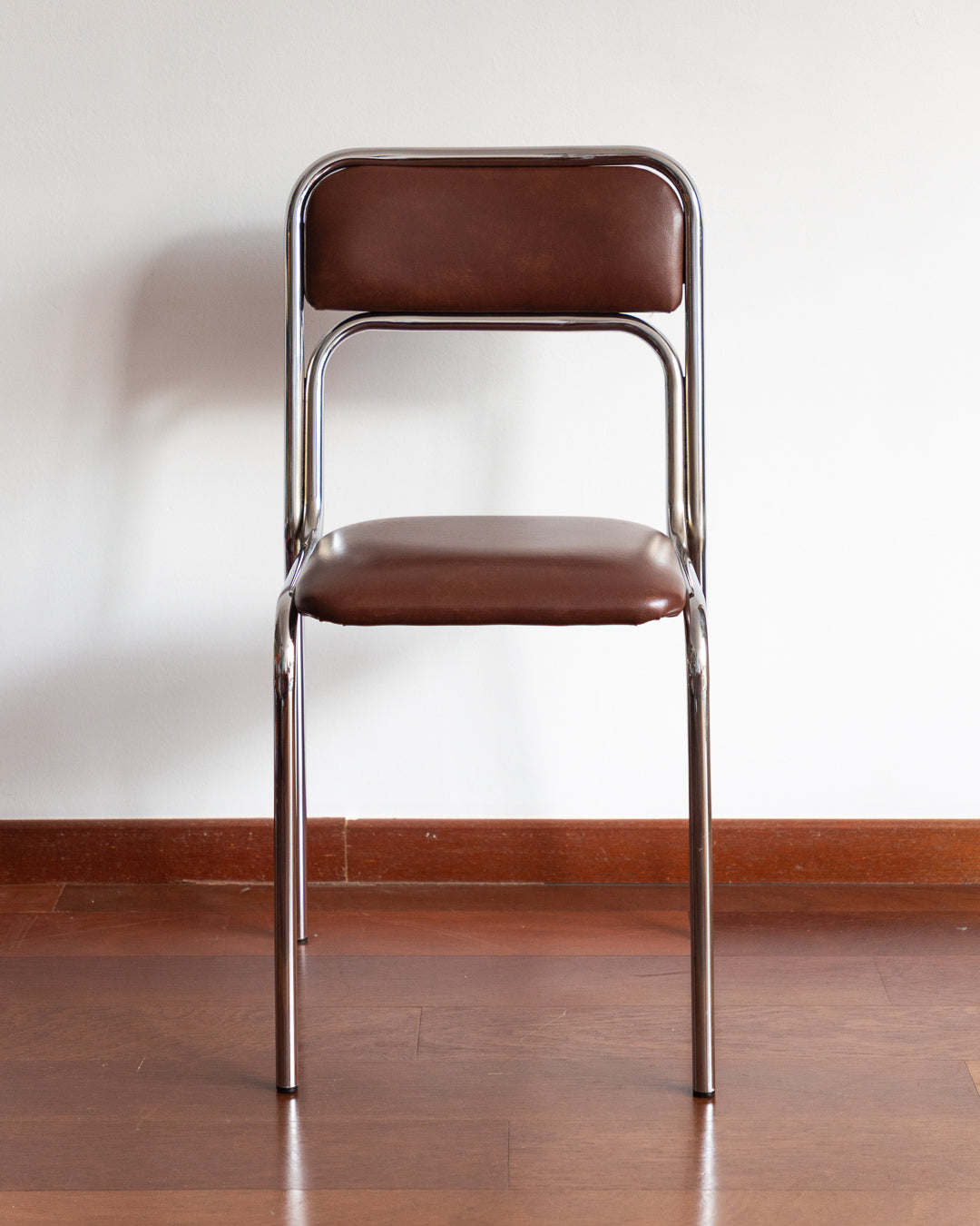 Set of five 1970s–80s Bauhaus-style chrome chairs with brown vinyl upholstery.