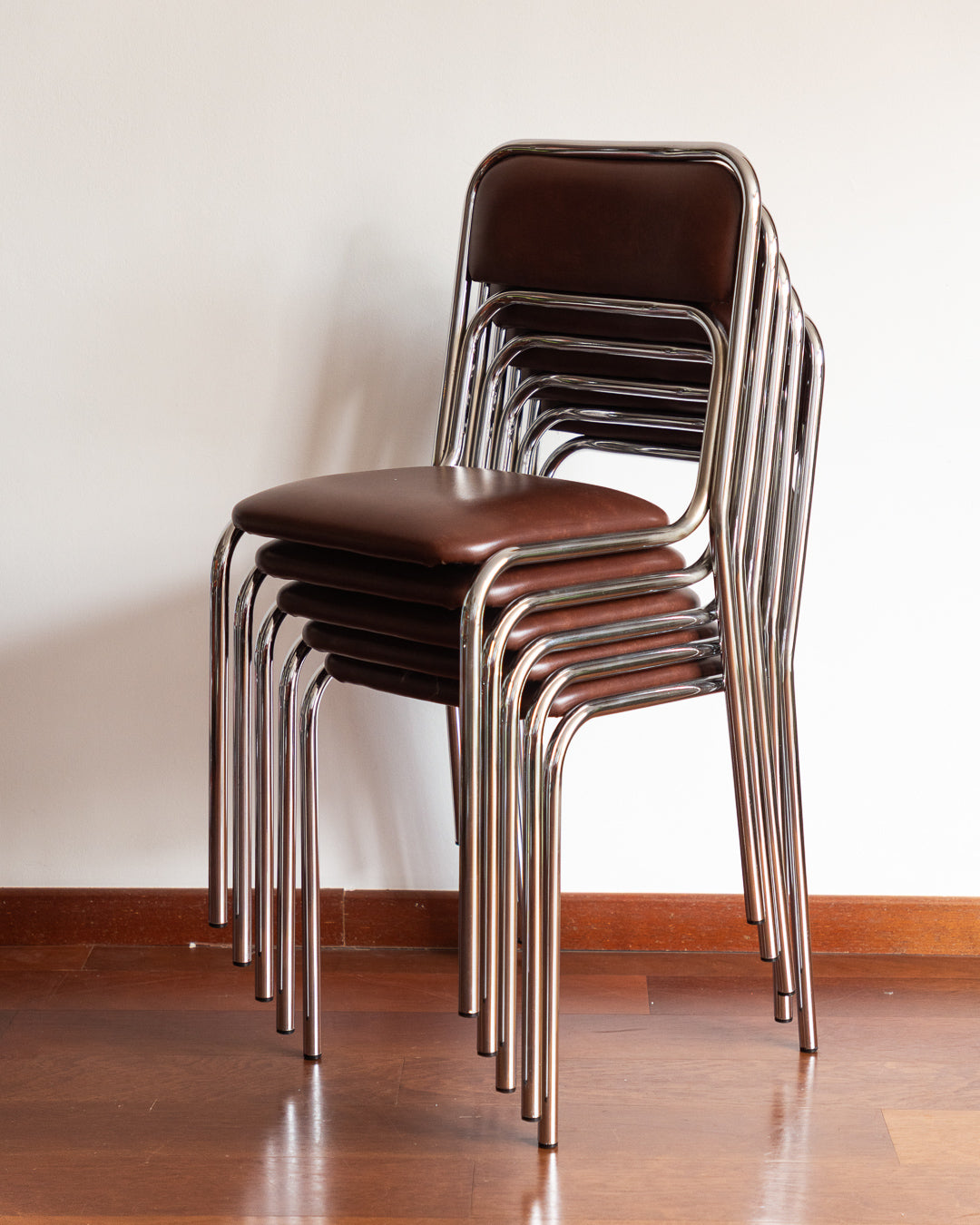 Set of five 1970s–80s Bauhaus-style chrome chairs with brown vinyl upholstery.