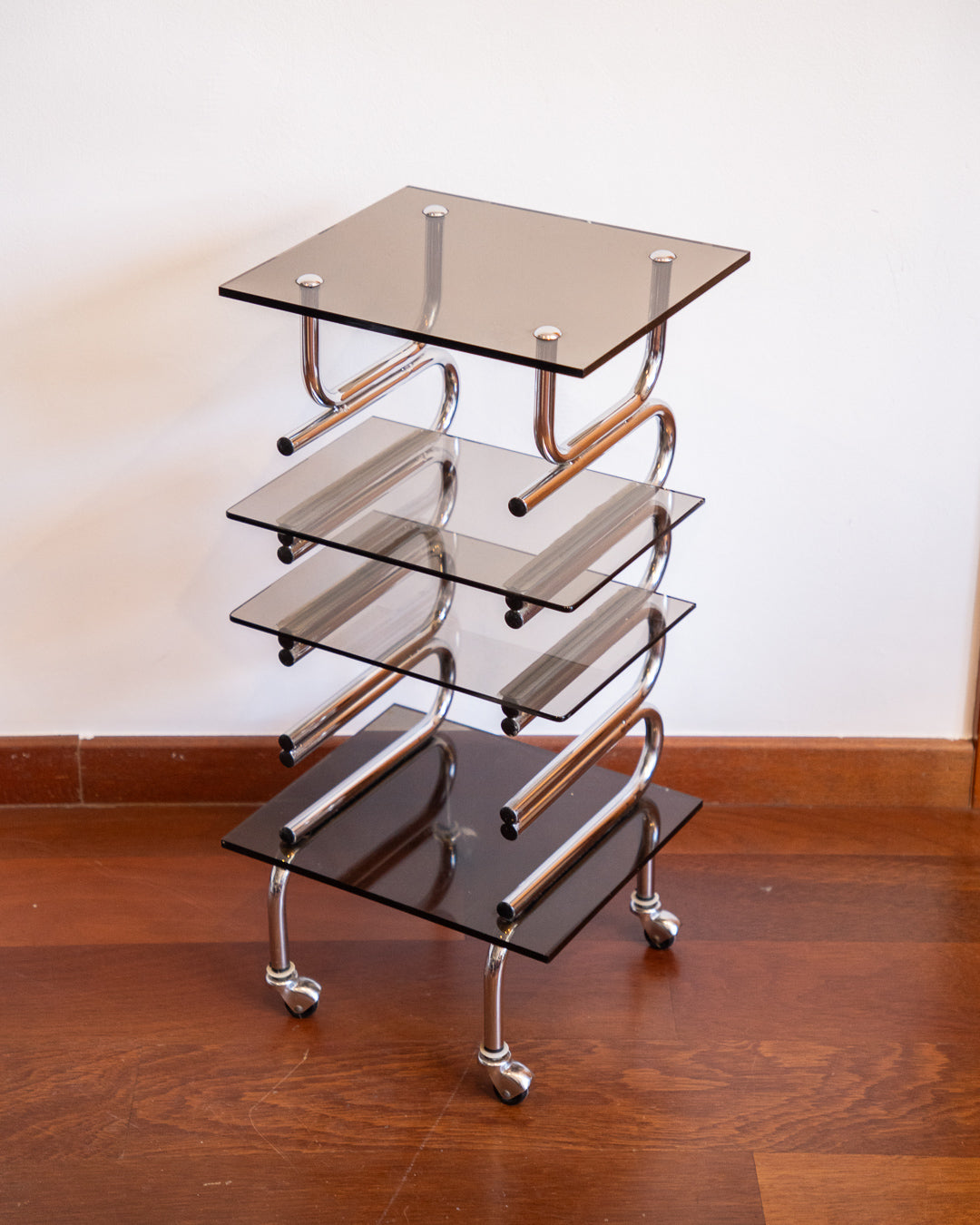 Chrome side table with acrylic and smoked glass shelves, 1970s vintage.