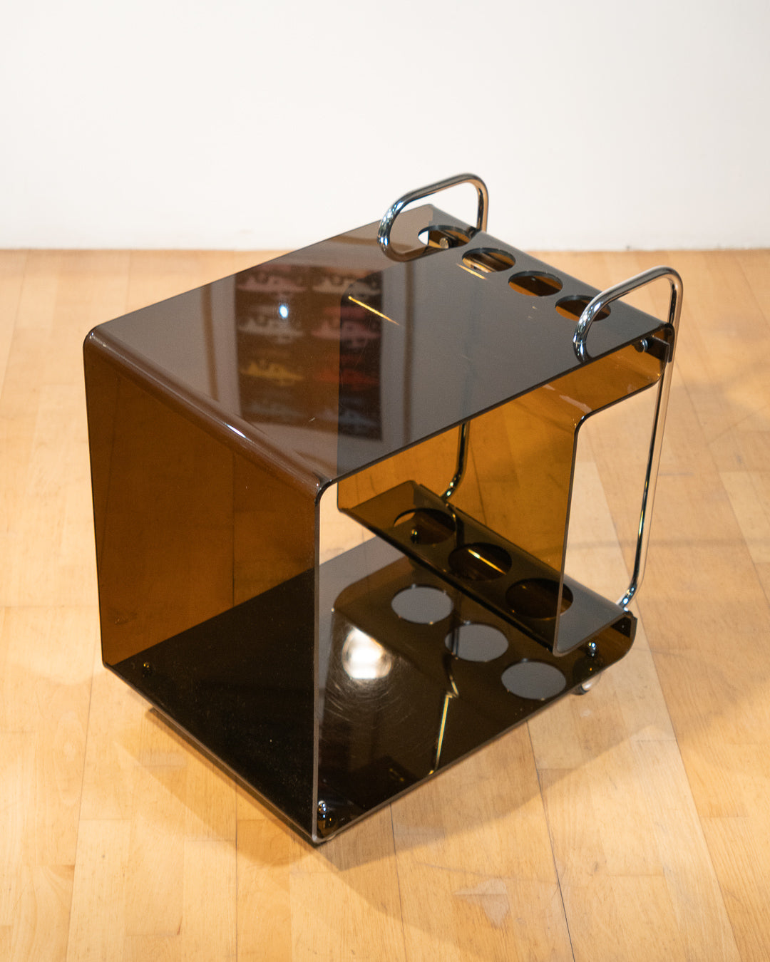 1970s smoked amber acrylic bar cart with chrome handles and casters, sculptural U-shaped design