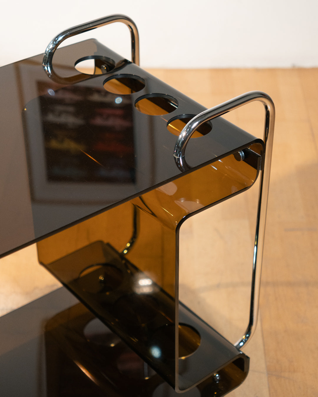 1970s smoked amber acrylic bar cart with chrome handles and casters, sculptural U-shaped design