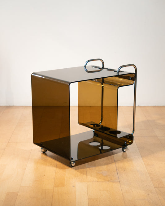 1970s smoked amber acrylic bar cart with chrome handles and casters, sculptural U-shaped design