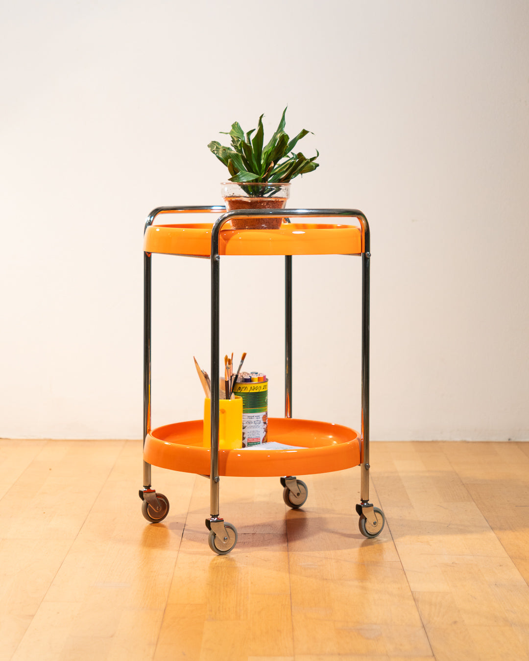 Rare 1970s round chrome bar cart with orange shelves, two tier design, restored vintage trolley with signs of use. Vecino Shop