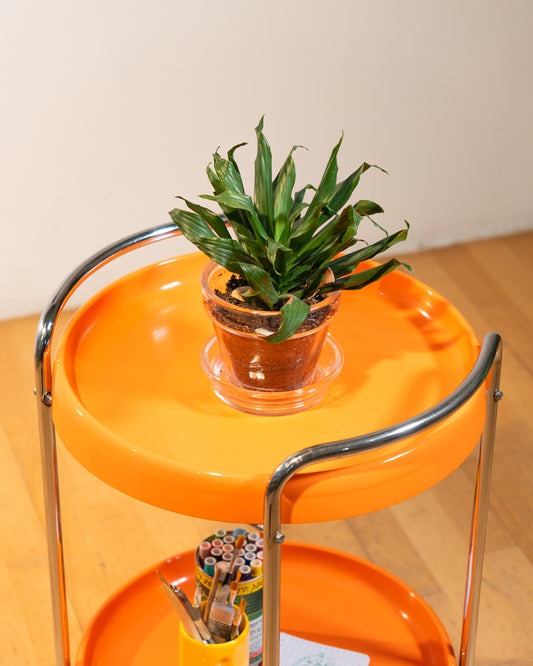 Rare 1970s round chrome bar cart with orange shelves, two tier design, restored vintage trolley with signs of use. Vecino Shop