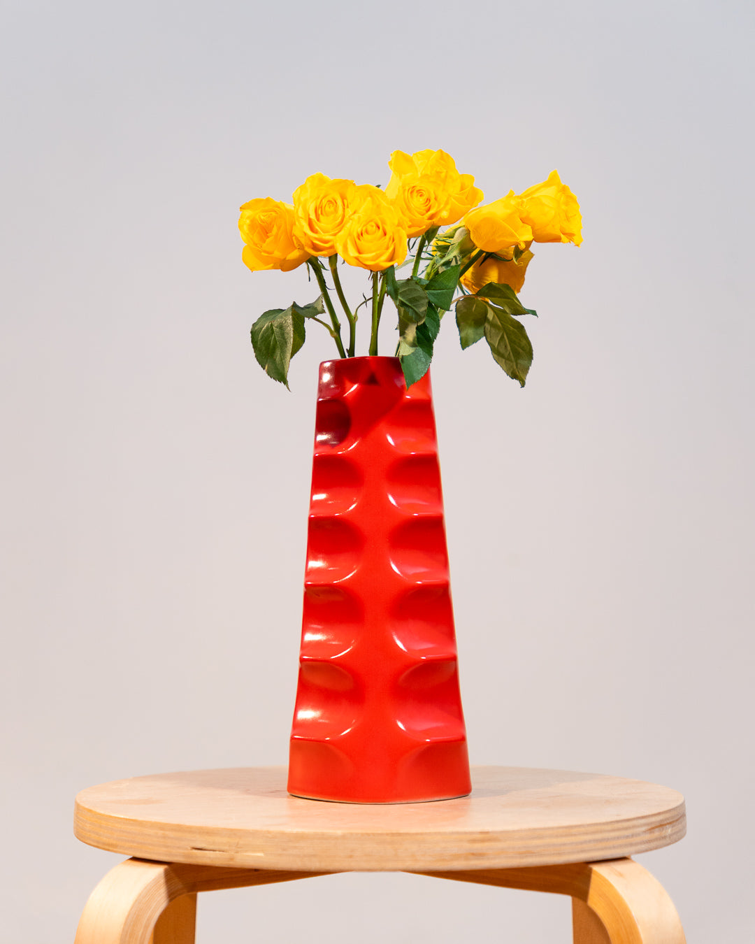 Vintage Molina Badalona ceramic flower vase from the 1970s in matte bright red glaze with wavy textured surface. Vecino Shop