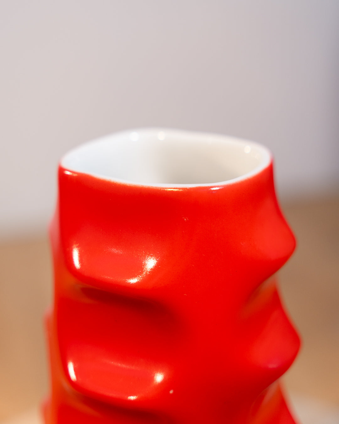 Vintage Molina Badalona ceramic flower vase from the 1970s in matte bright red glaze with wavy textured surface. Vecino Shop