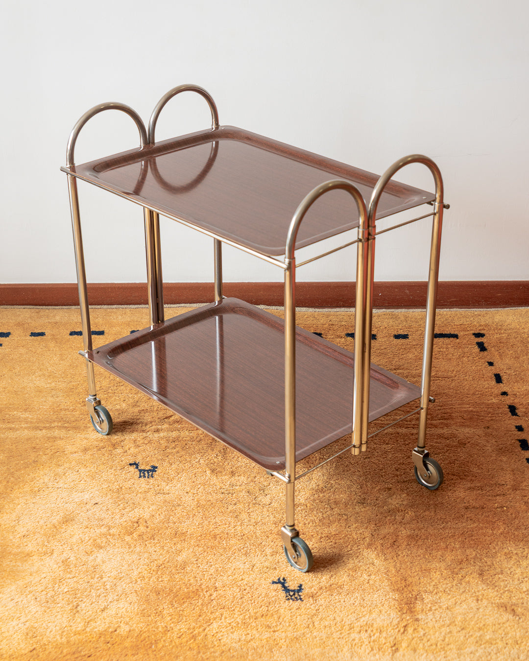 Vintage 1970s folding serving trolley with rare arched chrome frame and wood veneer shelves