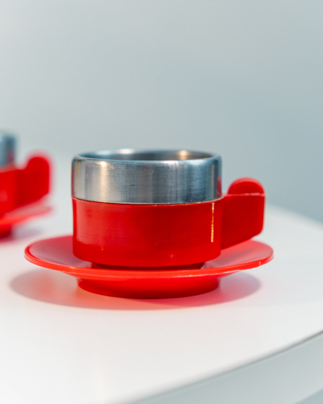 Vintage 1970s Jolly Rivadossi Italy double-walled stainless steel espresso cups with plastic red accent, saucers and sugar server. Vecino Shop