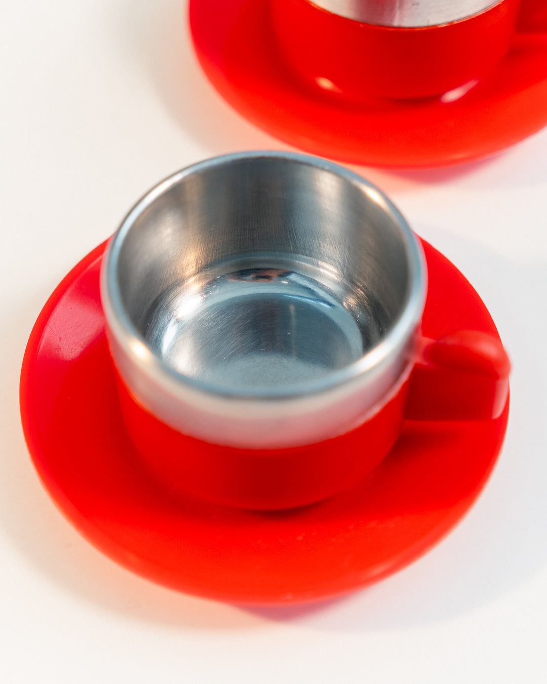 Vintage 1970s Jolly Rivadossi Italy double-walled stainless steel espresso cups with plastic red accent, saucers and sugar server. Vecino Shop