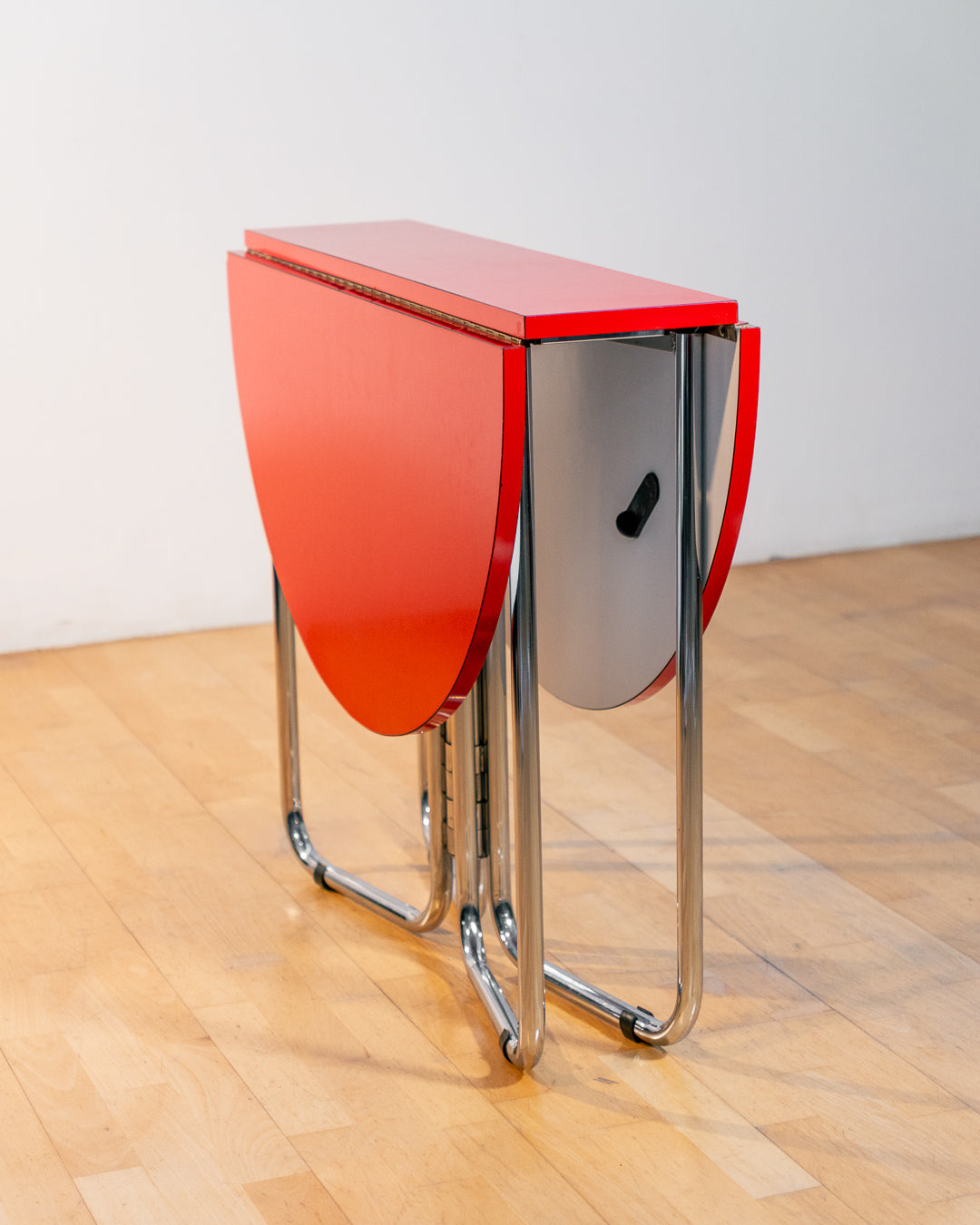 Vintage 1970s red Formica folding dining table with chrome frame and space-saving folding mechanism in Space Age style. Vecino Shop