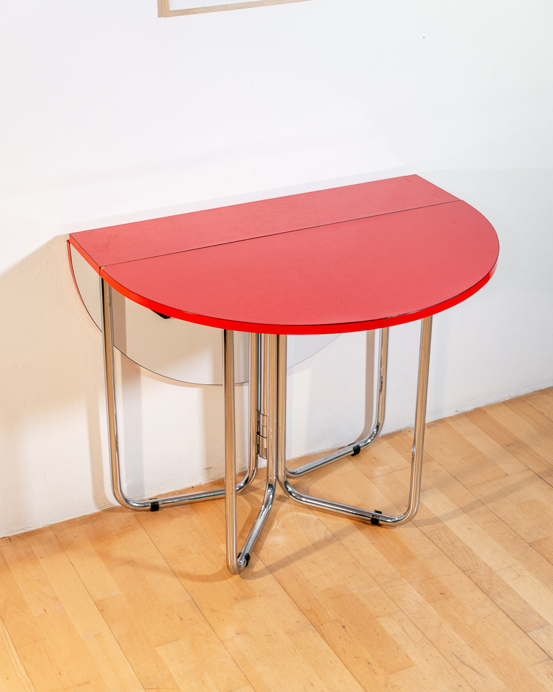 Vintage 1970s red Formica folding dining table with chrome frame and space-saving folding mechanism in Space Age style. Vecino Shop