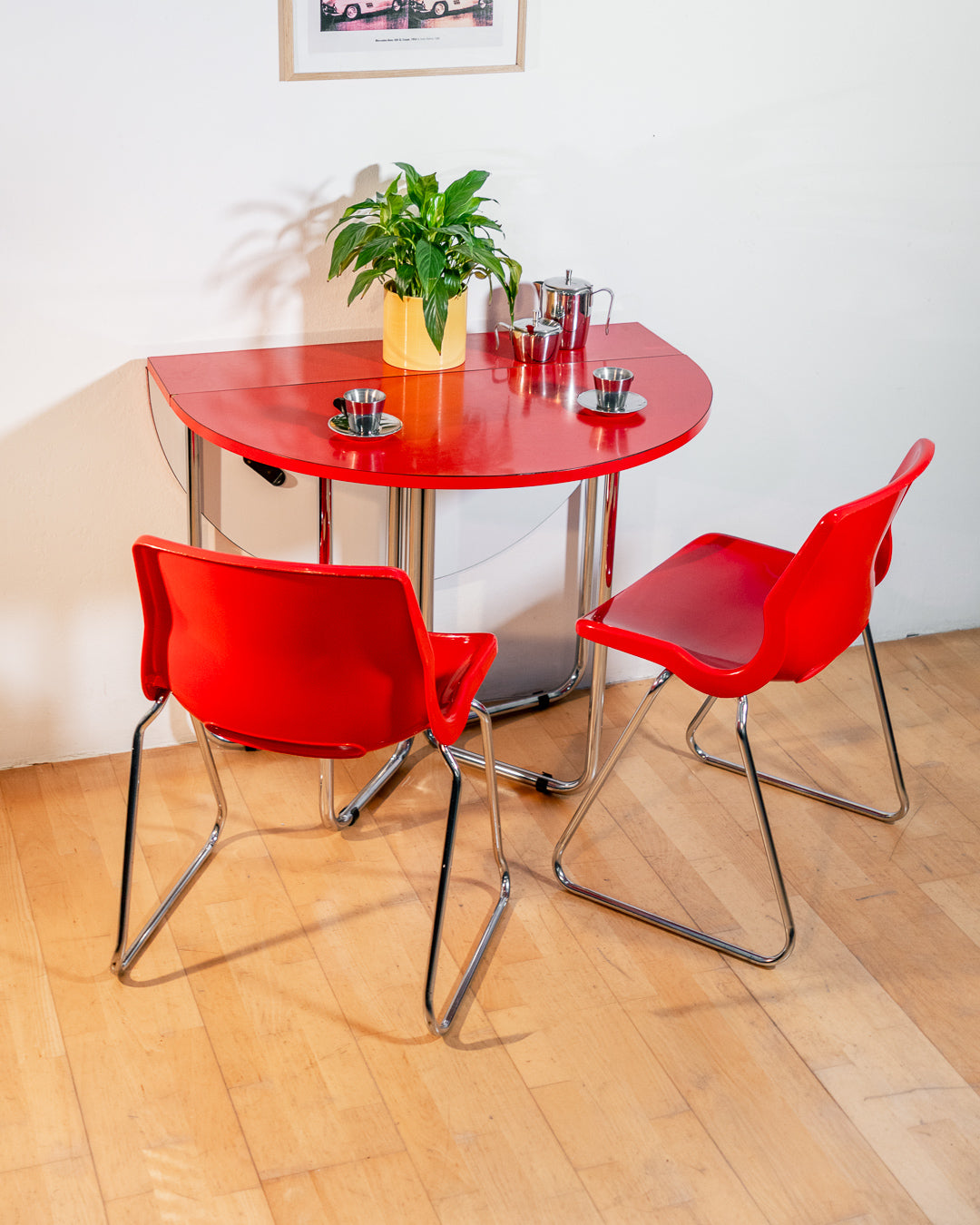 Vintage 1970s red Formica folding dining table with chrome frame and space-saving folding mechanism in Space Age style. Vecino Shop