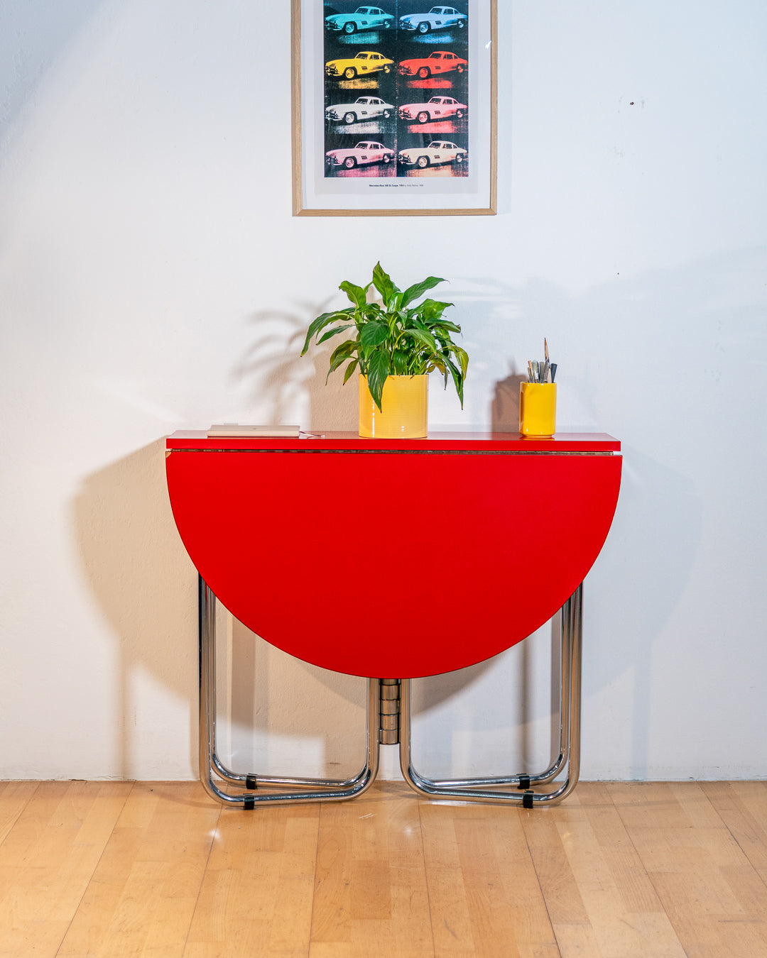 Vintage 1970s red Formica folding dining table with chrome frame and space-saving folding mechanism in Space Age style. Vecino Shop