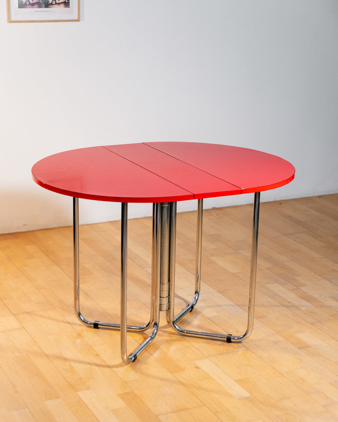 Vintage 1970s red Formica folding dining table with chrome frame and space-saving folding mechanism in Space Age style. Vecino Shop