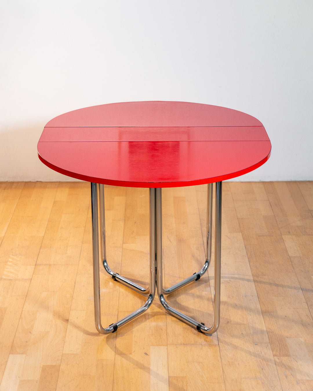 Vintage 1970s red Formica folding dining table with chrome frame and space-saving folding mechanism in Space Age style. Vecino Shop