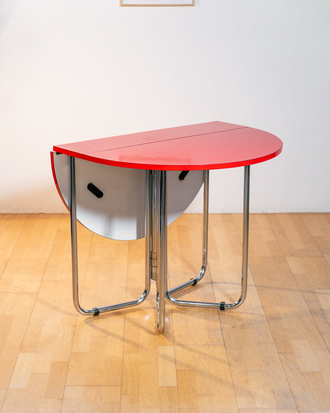 Vintage 1970s red Formica folding dining table with chrome frame and space-saving folding mechanism in Space Age style. Vecino Shop