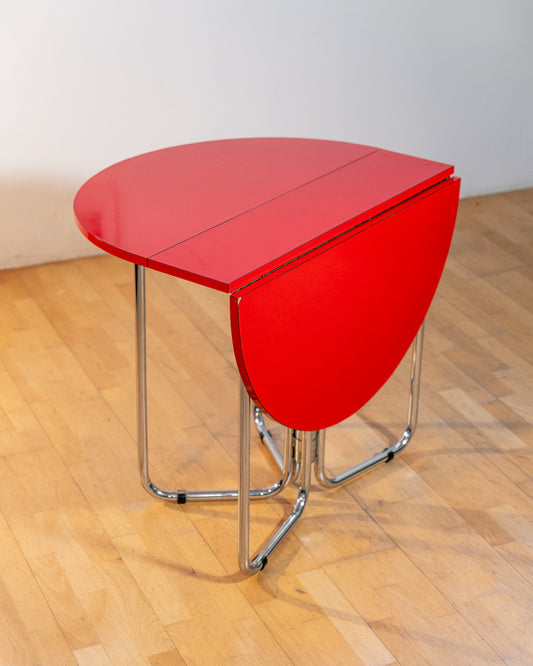 Vintage 1970s red Formica folding dining table with chrome frame and space-saving folding mechanism in Space Age style. Vecino Shop