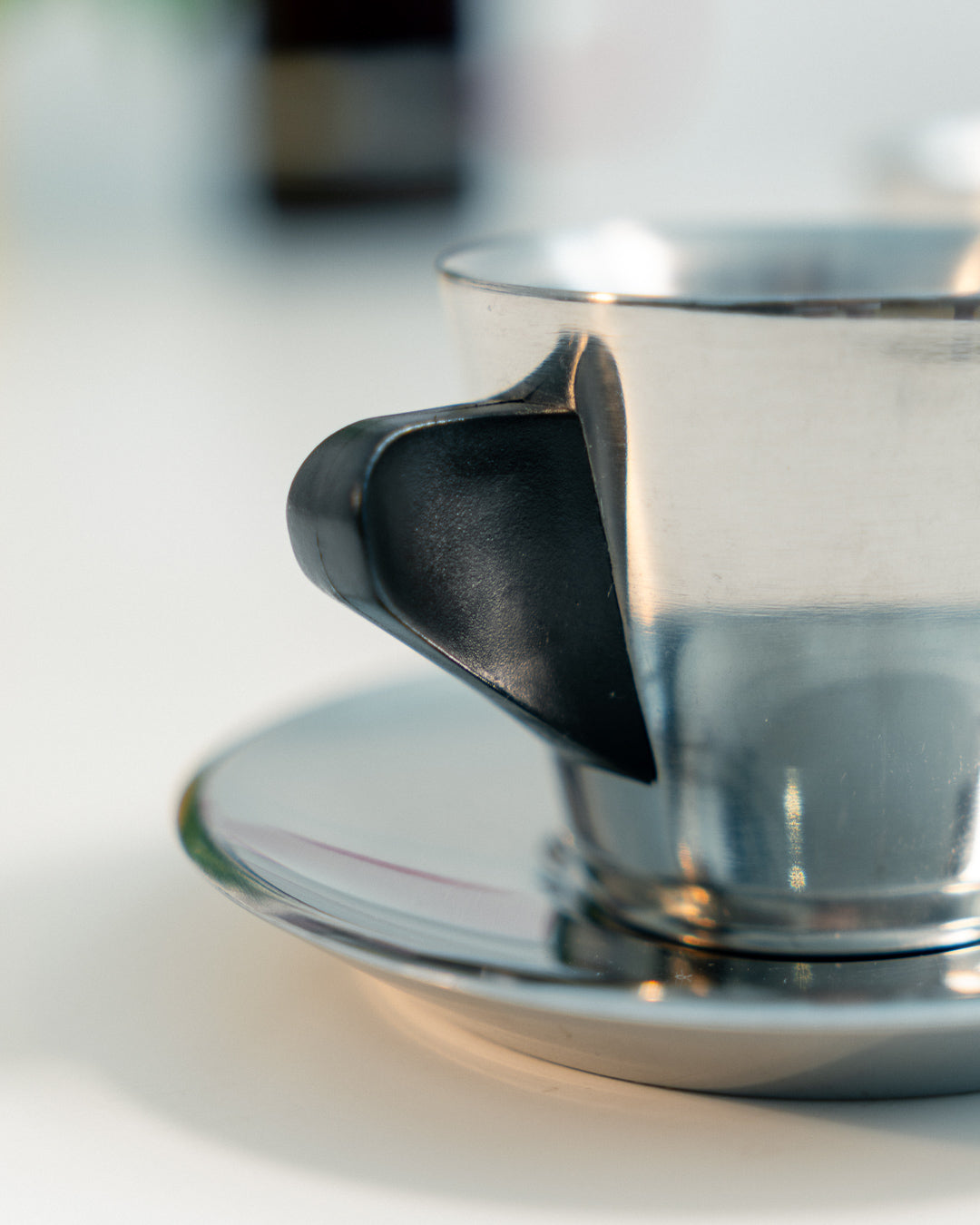 Vintage IKEA double-walled stainless steel espresso cup and saucer set from the 1990s with black plastic handles. Scandinavian minimalist design. Vecino Shop