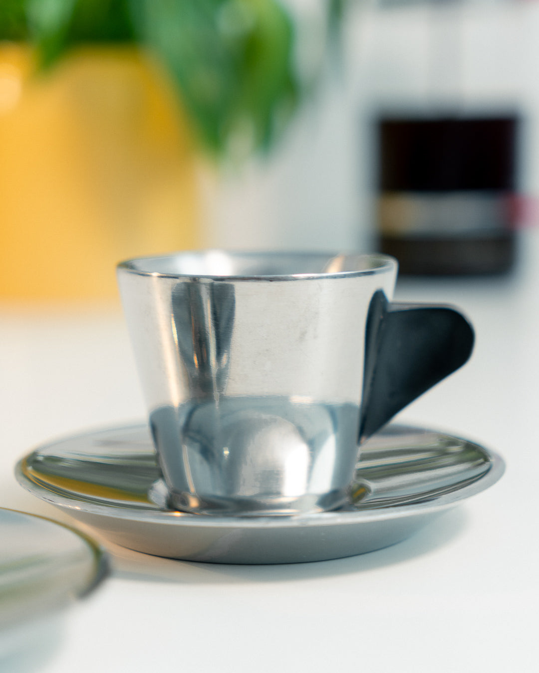 Vintage IKEA double-walled stainless steel espresso cup and saucer set from the 1990s with black plastic handles. Scandinavian minimalist design. Vecino Shop